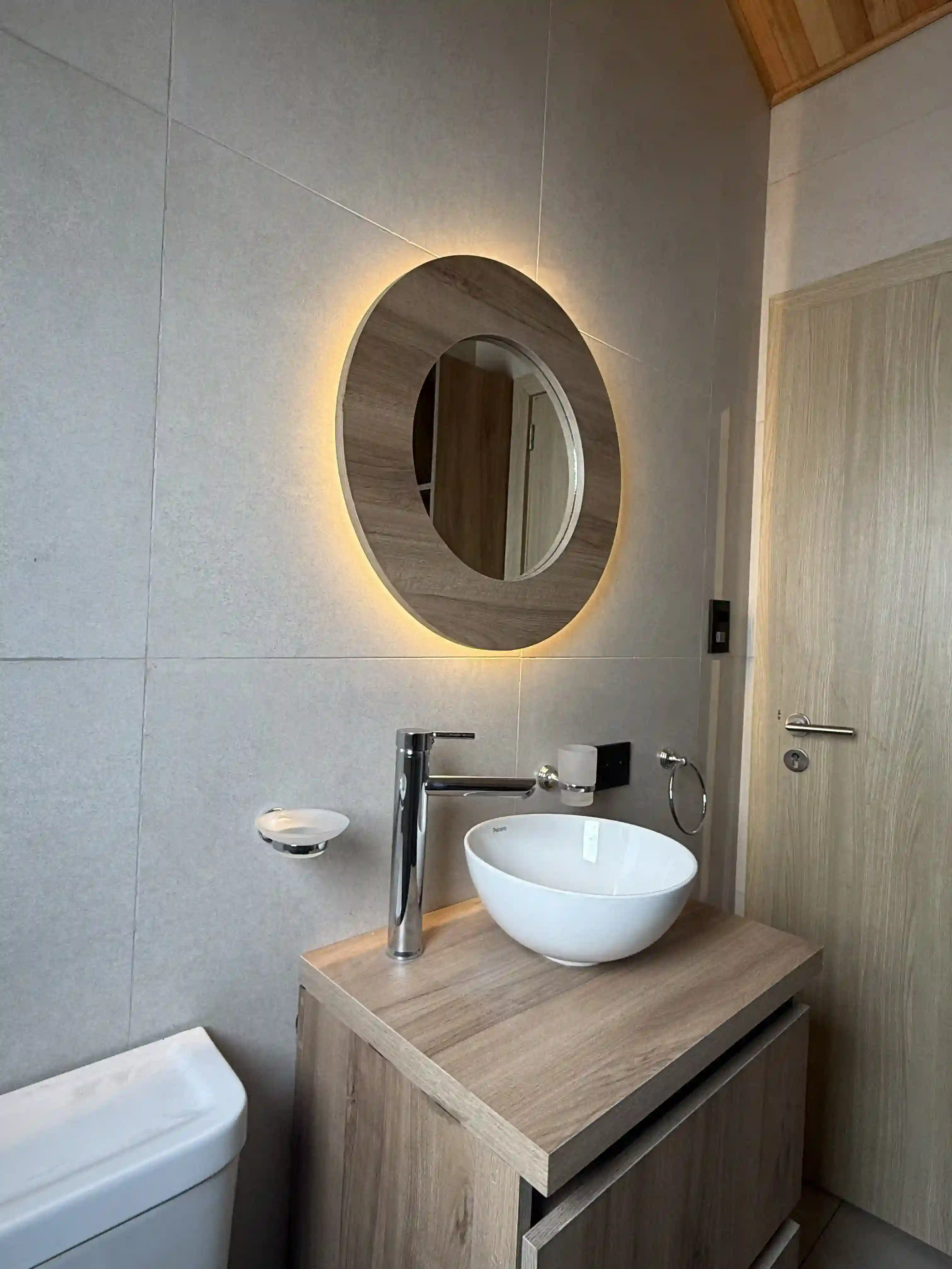 Baño con espejo circular con luz LED y bacha de apoyo casa modular Faci House