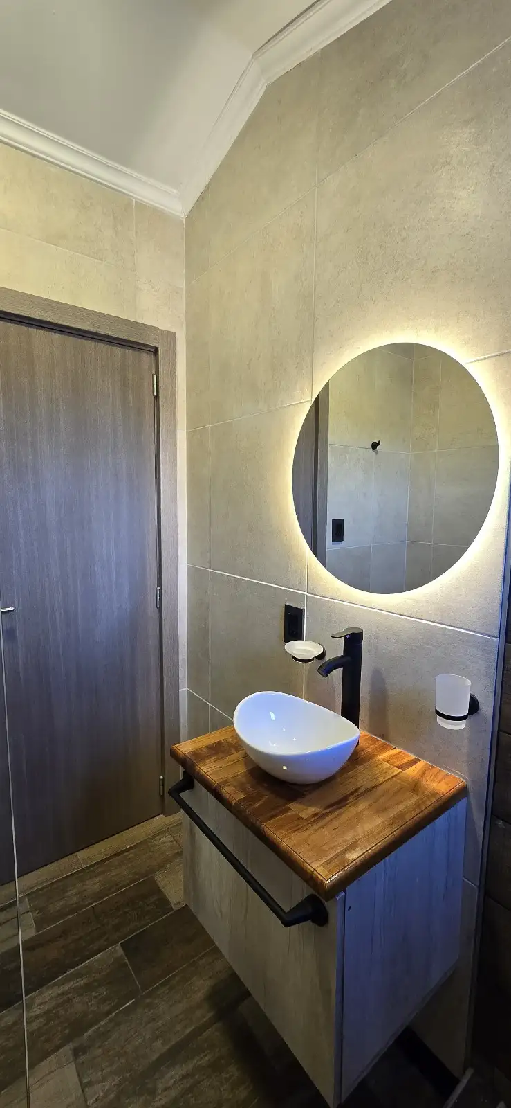 Baño con bacha de apoyo y espejo circular con luz LED casa modular Faci House